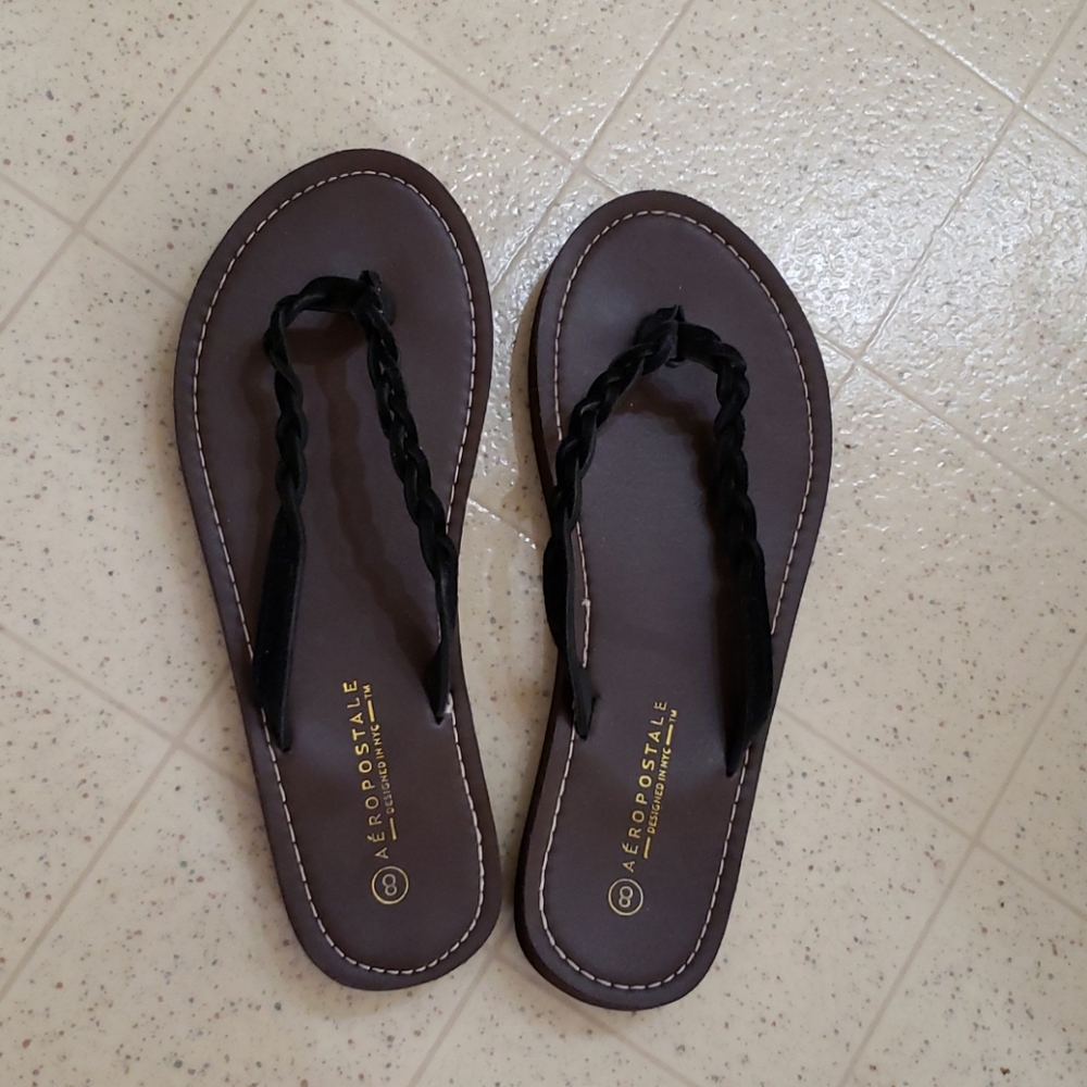 Brown and black flip flop sandals